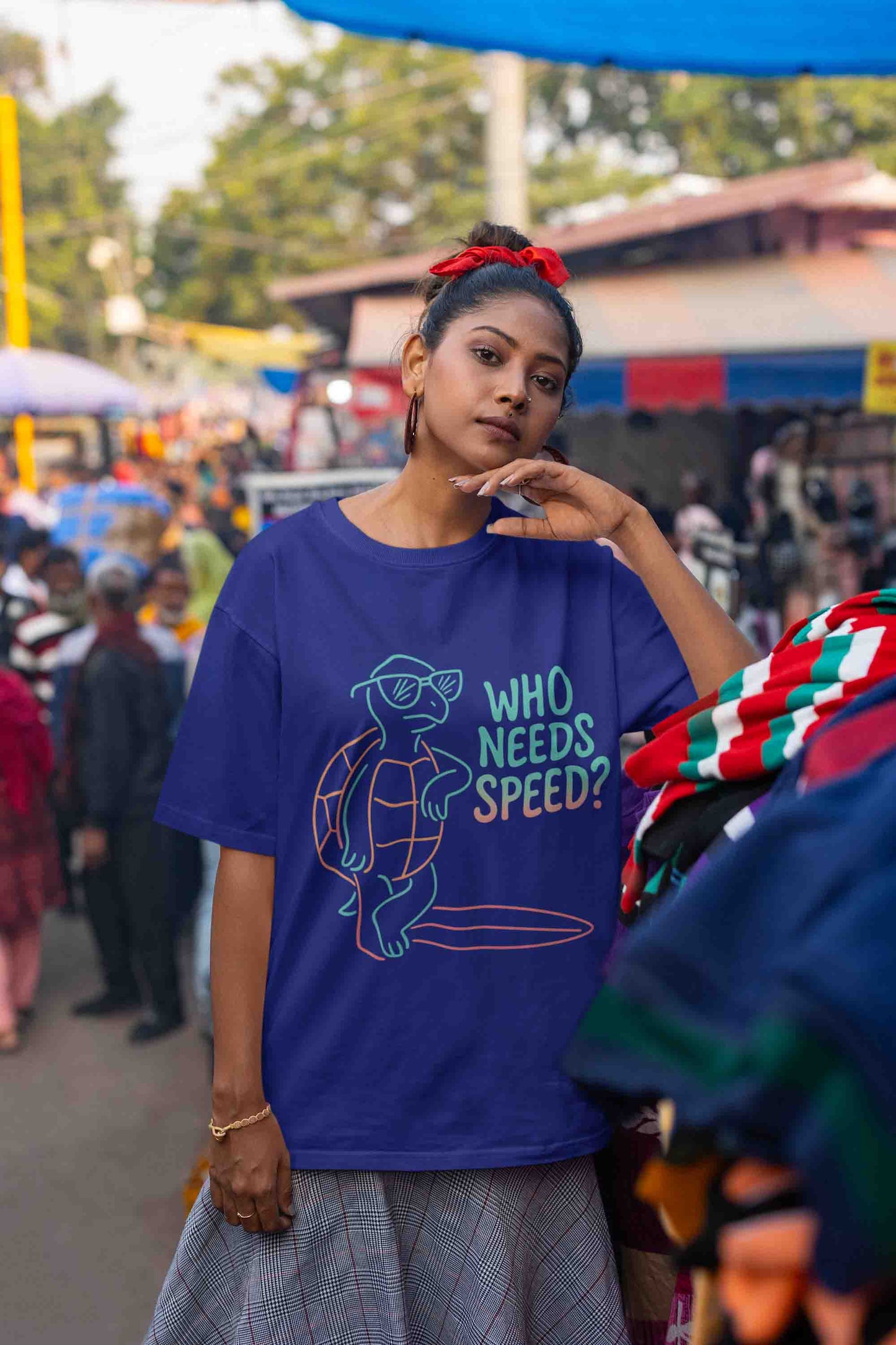 Oversized royal blue tee with neon pastel turtle and text: "Who Needs Speed?"
