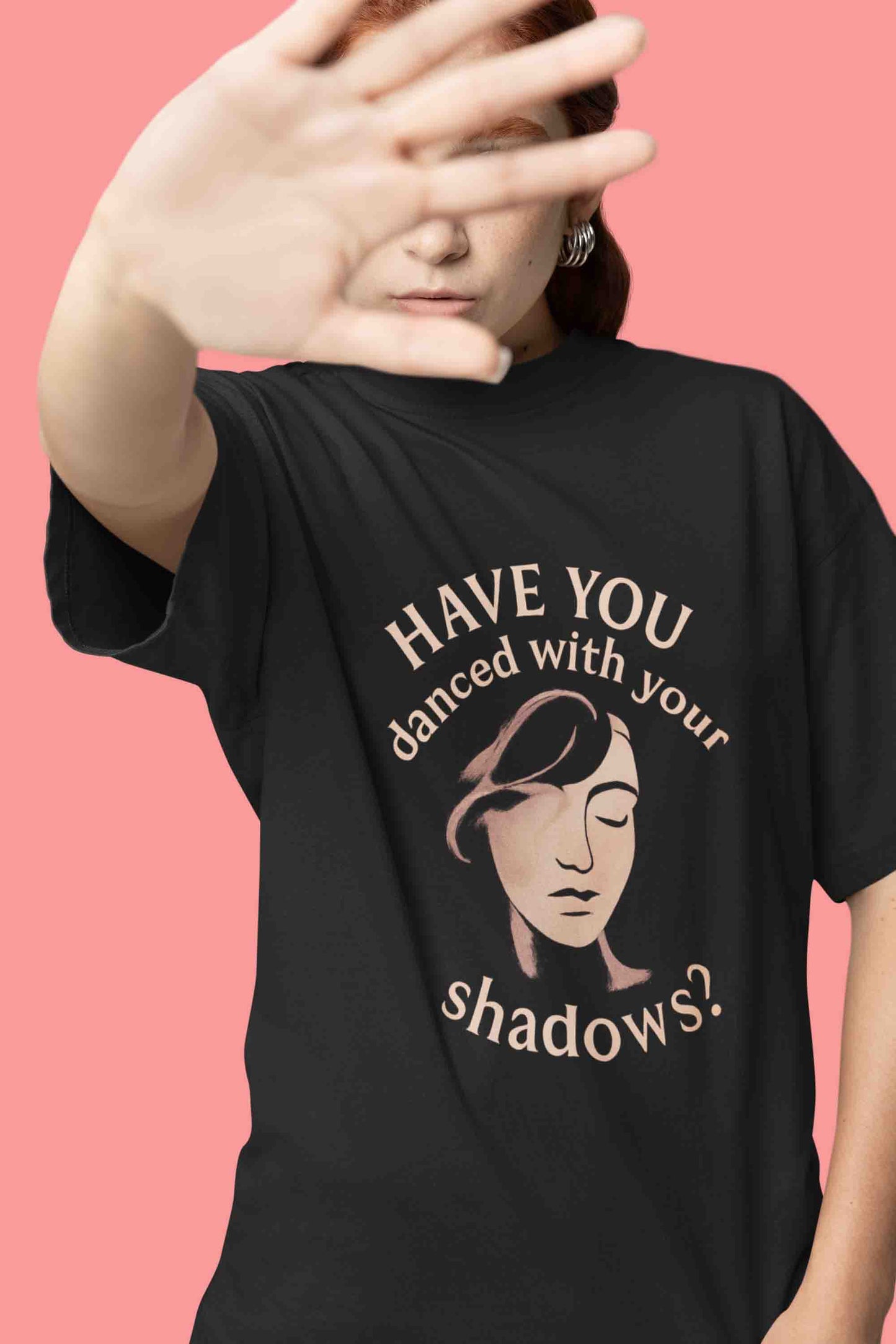 Close-up of a model in a black oversized tee with “Have You Danced With Your Shadows?” graphic