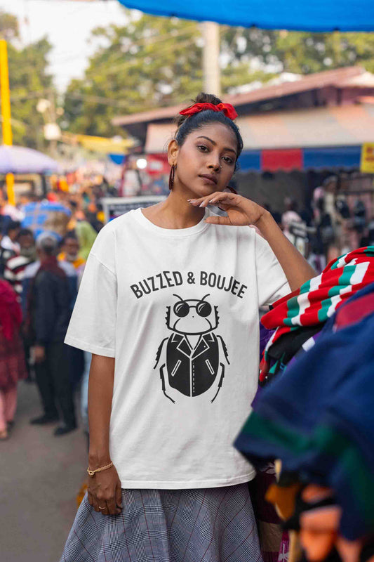 Oversized white t-shirt featuring 'Buzzed & Boujee' bug graphic print with a desi streetwear vibe
