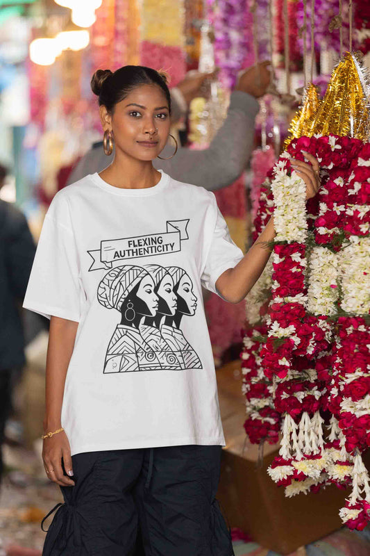 Woman wearing "Flexing Authenticity" tee at a vibrant market