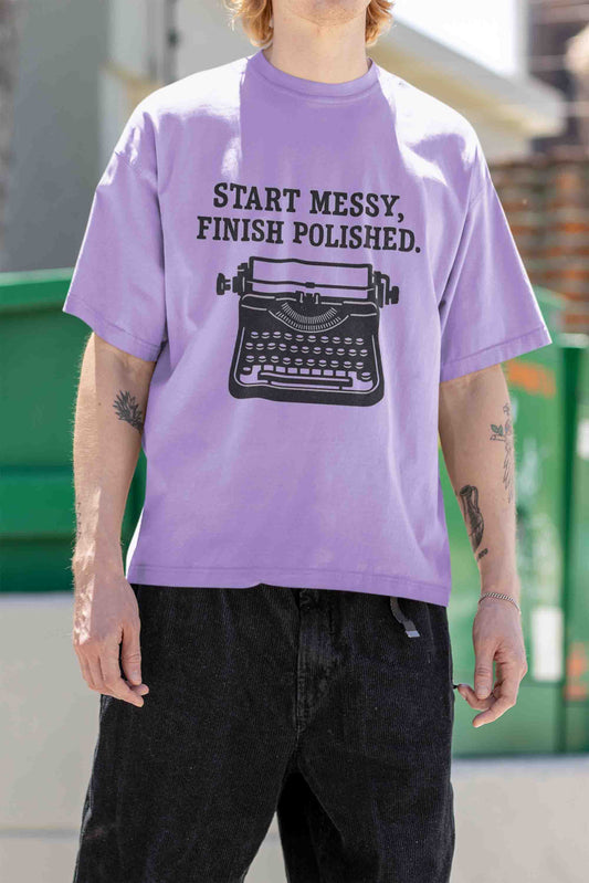 Man wearing oversized tee with arm‑tattoo, hip‑hop vibe
